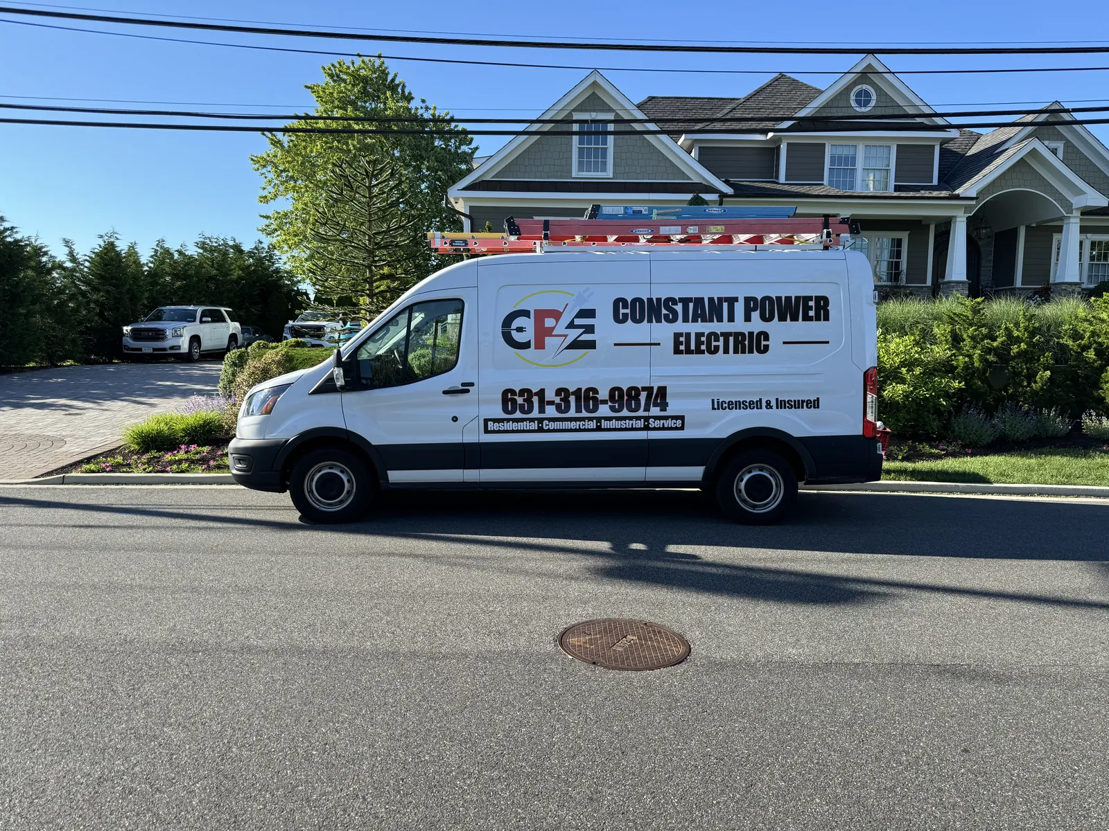 Constant Power Electric branded service van parked on a residential street